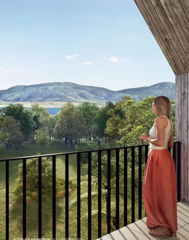 A resident taking in the lake and mountain view from a home